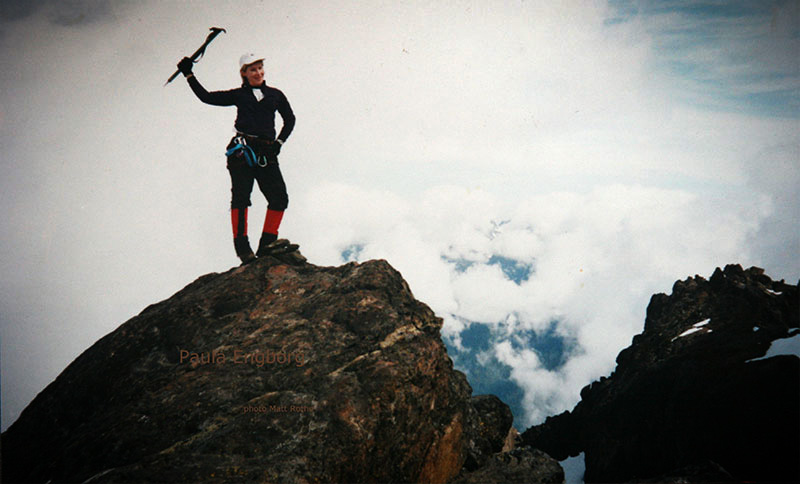 Climber posing on a mountaintop.
