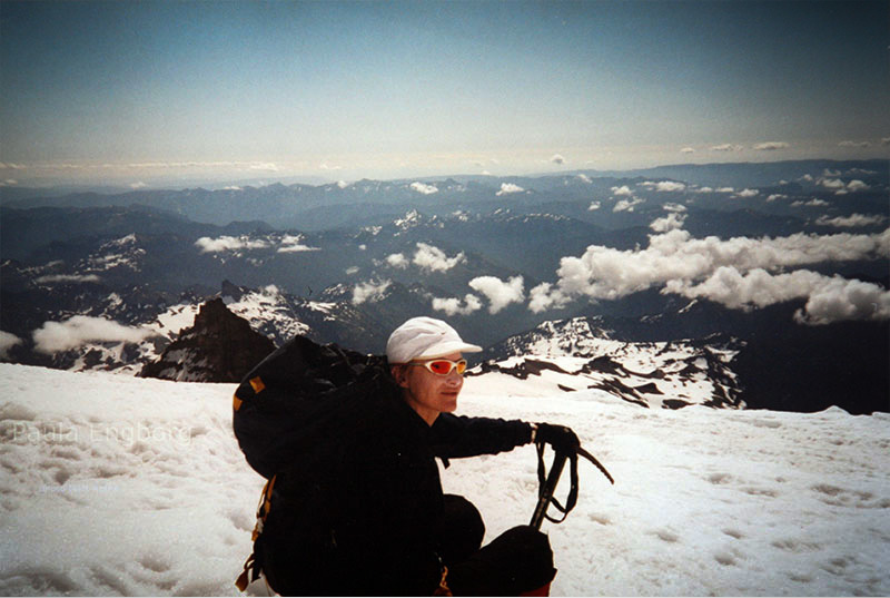 Climber looking into camera surrounded by snow.